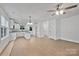Bright open concept kitchen with white cabinets, granite countertops, stainless appliances, and center island at 425 Messner St, Salisbury, NC 28144