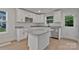 Bright kitchen features white cabinets, granite countertops, stainless appliances, and a kitchen island at 425 Messner St, Salisbury, NC 28144