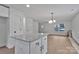 Bright kitchen features a center island with granite countertop and an open floor plan to living space at 425 Messner St, Salisbury, NC 28144