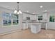 Bright kitchen features white cabinets, granite countertops, stainless appliances, and light-colored flooring at 425 Messner St, Salisbury, NC 28144