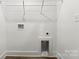 Clean laundry room featuring a wire shelf and utility connections for a washer and dryer at 425 Messner St, Salisbury, NC 28144