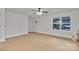 Bright and airy living room with neutral paint, wood-look flooring, ceiling fan, and natural light at 425 Messner St, Salisbury, NC 28144