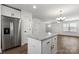 Open concept area with a kitchen island, stainless steel refrigerator and view of a living room at 425 Messner St, Salisbury, NC 28144