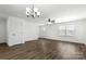 Bright living room with ample natural light, modern ceiling fan, chandelier, and beautiful flooring at 425 Messner St, Salisbury, NC 28144