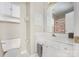 Cozy bathroom featuring a toilet and vanity with white cabinets and a framed mirror at 4507 Antelope Ln, Charlotte, NC 28269