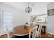 Bright dining area has a wood table with seating under decorative light fixture and leads to a kitchen at 4507 Antelope Ln, Charlotte, NC 28269