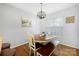 Charming dining room with wood table, cushioned bench and four chairs under a decorative chandelier at 4507 Antelope Ln, Charlotte, NC 28269