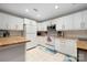 Bright kitchen featuring white cabinets, stainless steel appliances, and a tile backsplash at 4507 Antelope Ln, Charlotte, NC 28269