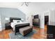 Spacious main bedroom features a ceiling fan, soft blue accent wall, and dark wood furniture at 4507 Antelope Ln, Charlotte, NC 28269