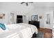 Bright main bedroom includes ceiling fan, dresser with mirror and ensuite bathroom at 4507 Antelope Ln, Charlotte, NC 28269