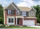 Two-story home featuring brick and siding, an attached garage and a well-manicured lawn at 4625 Potters Wheel Dr, Fort Mill, SC 29715