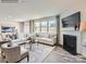 Well-lit living room showcasing large windows, fireplace, and comfortable seating arrangement at 4625 Potters Wheel Dr, Fort Mill, SC 29715