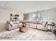 Spacious living room with a large sectional sofa, accent pillows, and a window offering natural light and a cozy atmosphere at 4625 Potters Wheel Dr, Fort Mill, SC 29715