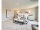 This spacious main bedroom is elegantly appointed with stylish furnishings, neutral decor, and plush carpeting at 4625 Potters Wheel Dr, Fort Mill, SC 29715