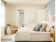 Well-lit bedroom with soft blue and beige accents, showcasing bed, pillows, and side table at 4633 Potters Wheel Dr, Fort Mill, SC 29715
