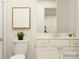 Bright bathroom with a white vanity, framed mirror, and a decorative geometric print above the toilet at 4641 Potters Wheel Ct, Fort Mill, SC 29715