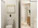 Clean bathroom with toilet, vanity, and view into an adjoining room with dresser at 4641 Potters Wheel Ct, Fort Mill, SC 29715