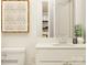 Modern bathroom vanity with a decorative mirror, ample countertop space, and clean white fixtures at 4641 Potters Wheel Ct, Fort Mill, SC 29715