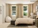 Bedroom with large windows and comfortable bed featuring neutral tones and tasteful decorations at 4641 Potters Wheel Ct, Fort Mill, SC 29715