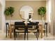 Dining room with a round mirror, plants, a wooden table, and seating for six at 4641 Potters Wheel Ct, Fort Mill, SC 29715