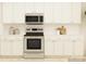 The kitchen features stainless steel appliances, white cabinets, and ample counter space at 4641 Potters Wheel Ct, Fort Mill, SC 29715