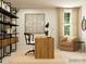 Bright home office with a modern desk, open shelving, and comfortable seating area at 4641 Potters Wheel Ct, Fort Mill, SC 29715