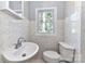 Cozy bathroom features marble tile, a modern sink, and a window view at 4924 Jane Ave, Charlotte, NC 28269