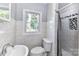 Cozy bathroom features marble tile, a modern sink, and a window view at 4924 Jane Ave, Charlotte, NC 28269