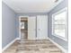 Bright bedroom features wood flooring, gray walls, and a window, creating a serene living space at 4924 Jane Ave, Charlotte, NC 28269