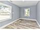 Bright bedroom with hardwood floors, natural light from large windows, and fresh paint at 4924 Jane Ave, Charlotte, NC 28269