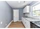 Kitchen featuring white cabinets, granite countertops, stainless sink, and updated appliances at 4924 Jane Ave, Charlotte, NC 28269