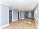 Bright, open-concept living area featuring new hardwood flooring, freshly painted walls, and a modern lighting at 4924 Jane Ave, Charlotte, NC 28269