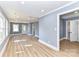 View of a spacious, freshly painted living room with hardwood floors, bright windows, and modern lighting at 4924 Jane Ave, Charlotte, NC 28269