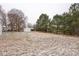 Large backyard with a storage shed on a snow-covered lot at 5028 Wilgrove Mint Hill Rd, Mint Hill, NC 28227