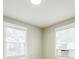 Bedroom with two windows featuring neutral carpet, paint and trim at 5028 Wilgrove Mint Hill Rd, Mint Hill, NC 28227