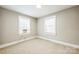 Bedroom with two windows featuring neutral carpet, paint and trim at 5028 Wilgrove Mint Hill Rd, Mint Hill, NC 28227