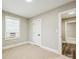 Bedroom featuring neutral carpet, paint and trim, with window and door at 5028 Wilgrove Mint Hill Rd, Mint Hill, NC 28227