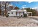 Charming white home featuring a covered carport, front porch, and landscaped yard dusted with snow at 5028 Wilgrove Mint Hill Rd, Mint Hill, NC 28227