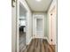 Hallway with neutral walls, luxury vinyl plank flooring and white trim at 5028 Wilgrove Mint Hill Rd, Mint Hill, NC 28227