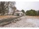 Exterior view of a snow-covered lot with a white home and driveway at 5028 Wilgrove Mint Hill Rd, Mint Hill, NC 28227