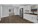 Well-lit kitchen with modern appliances, white cabinetry, and wood-look floors, offering a spacious layout at 5028 Wilgrove Mint Hill Rd, Mint Hill, NC 28227