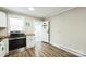 Spacious kitchen with stainless steel appliances, wood countertops, and luxury vinyl plank flooring at 5028 Wilgrove Mint Hill Rd, Mint Hill, NC 28227