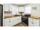 This kitchen features white cabinets, stainless steel appliances, and wood countertops at 5028 Wilgrove Mint Hill Rd, Mint Hill, NC 28227