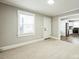 Inviting living room with large windows and carpet, seamlessly connecting to the adjacent kitchen at 5028 Wilgrove Mint Hill Rd, Mint Hill, NC 28227