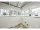 Bright room with wood-look floors and multiple large windows at 5028 Wilgrove Mint Hill Rd, Mint Hill, NC 28227