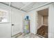 Utility room featuring wood-look floors, modern water heater, and white doors at 5028 Wilgrove Mint Hill Rd, Mint Hill, NC 28227