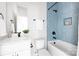 Stylish bathroom with blue tiled shower, white vanity, and modern fixtures at 5404 Maplewood Ln, Charlotte, NC 28227