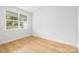 A clean bedroom with a large window and wood floors at 5404 Maplewood Ln, Charlotte, NC 28227