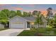 Charming single-story home features a manicured lawn, attached garage, and welcoming front porch at 5404 Maplewood Ln, Charlotte, NC 28227