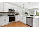 Modern kitchen featuring stainless appliances, stone countertops, and ample white cabinetry at 5404 Maplewood Ln, Charlotte, NC 28227